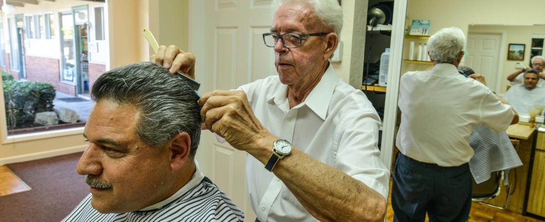 A barber giving a client a haircut.