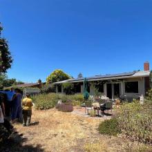 Real estate agents explore San Rafael house to learn about green home upgrades.