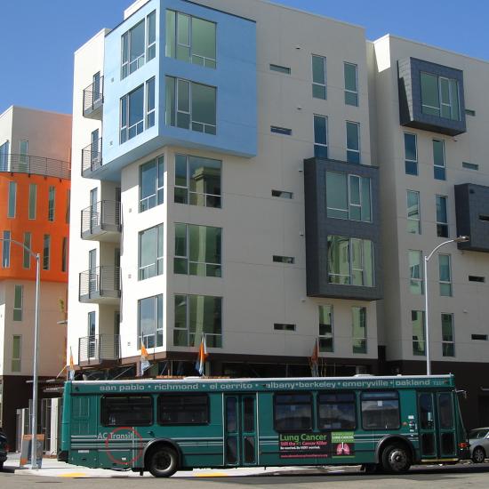 Apartment buildings with a bus in front of it