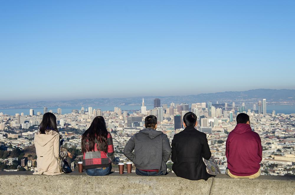 Four people sitting and looking at San Francisco skyline