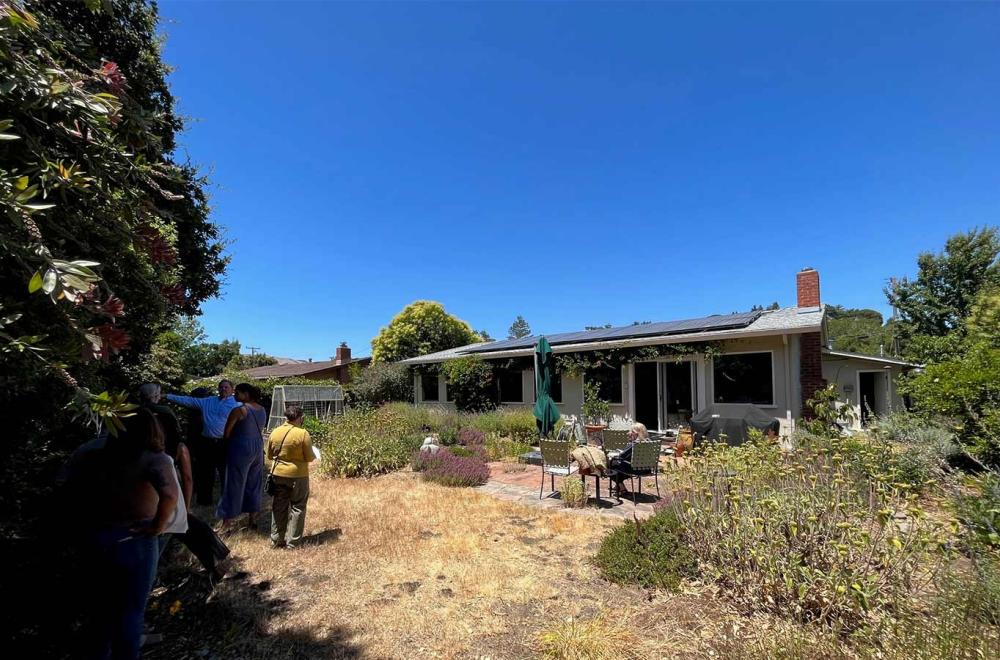 Real estate agents explore San Rafael house to learn about green home upgrades.